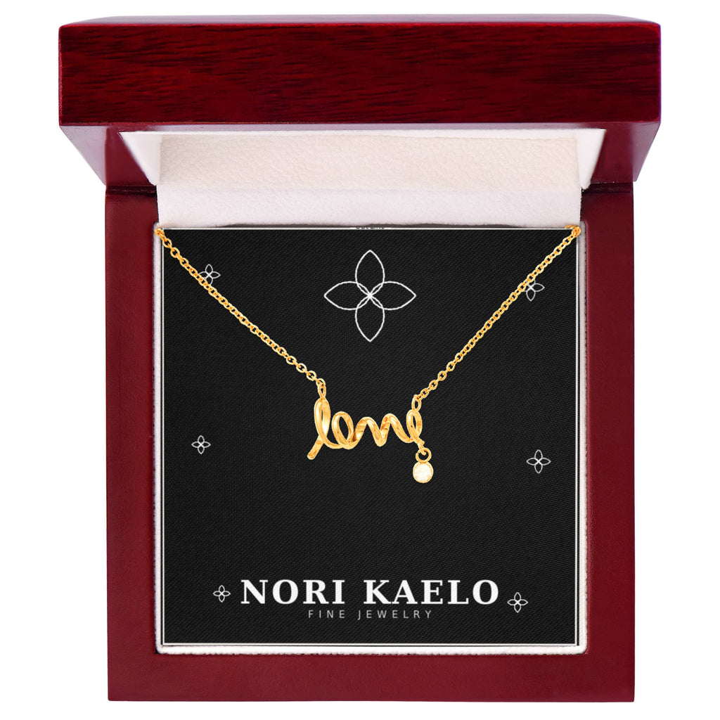 Cursive love pendant necklace in yellow gold finish, displayed in a mahogany-style luxury gift box.
