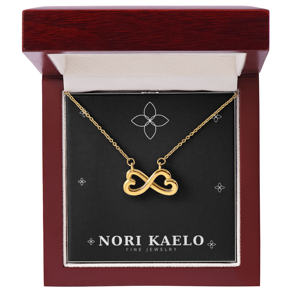 Infinity heart pendant necklace in yellow gold finish, displayed in a mahogany-style luxury gift box.