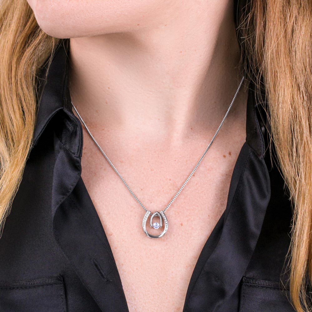 Close-up of a woman wearing the Dancing Stone Necklace in white gold.