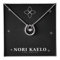 Dancing stone pendant necklace in white gold, displayed on a black Nori Kaelo Fine Jewelry gift box.
