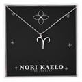 Zodiac Sign Necklace in stainless steel with Aries pendant, displayed on Nori Kaelo jewelry card.